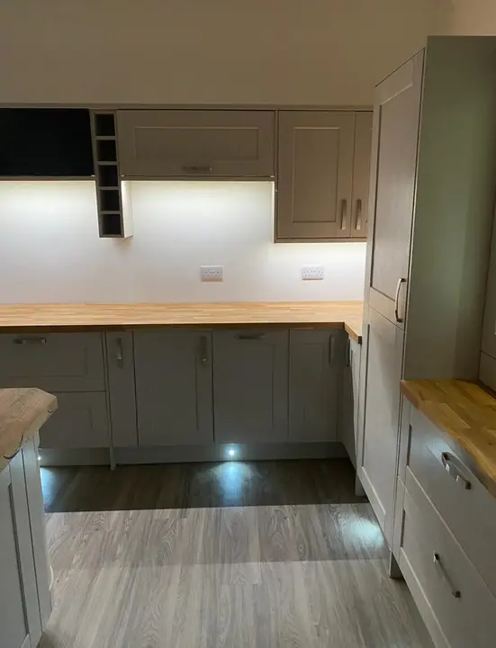 Under-cabinet LED lighting and new double sockets in a grey shaker kitchen