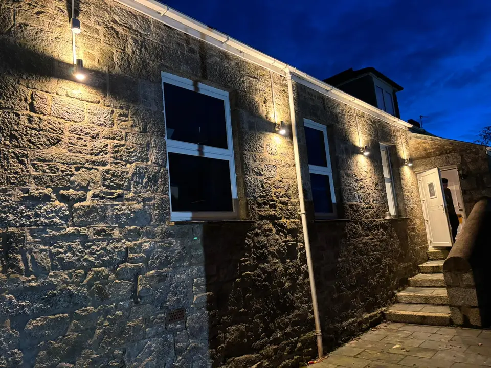 Outdoor wall lights installed on a Cornish granite cottage
