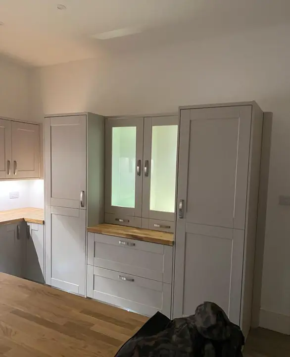 Illuminated glass display cabinets in a fitted kitchen