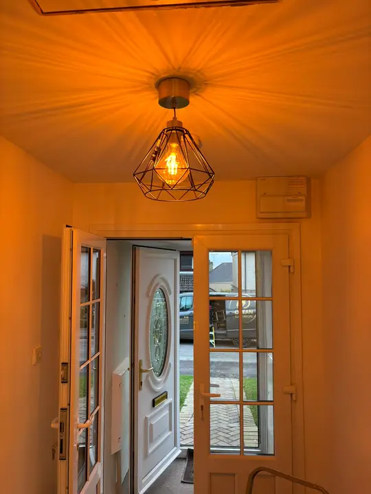 Geometric pendant light installed in an entrance hallway